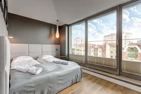 The first bedroom is an oasis of peace and comfort. A large bed with a soft, upholstered headboard and carefully selected linens guarantees excellent sleep. 