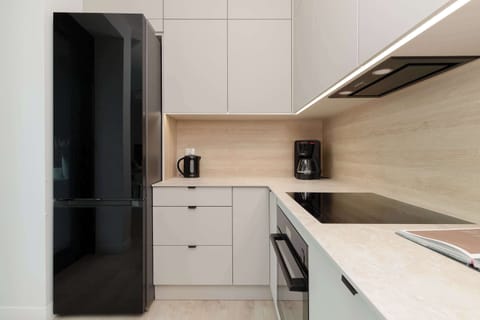 A fully equipped, modern kitchen with built-in appliances and ample storage.