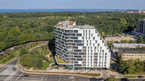 A view of the modern residential building surrounded by greenery.