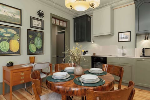 A view of the dining area prepared for a meal, with neatly arranged plates and rustic tableware.