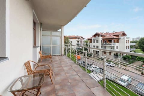 A balcony with outdoor chairs and a small table, offering a relaxing spot to enjoy the view.