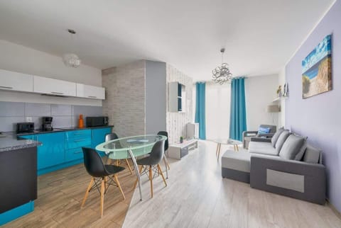 The living room opens onto a balcony with a view of the quiet surroundings.