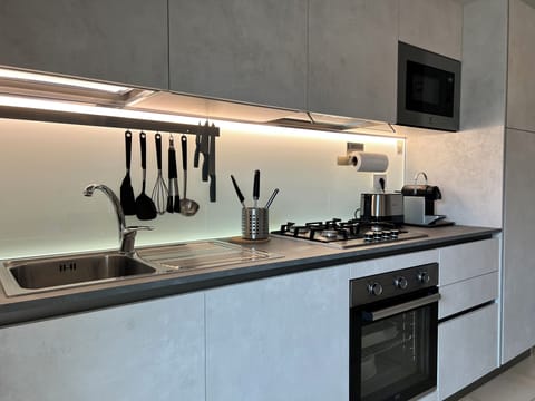 The kitchen is equipped with dishwasher, hob, oven, microwave, fridge