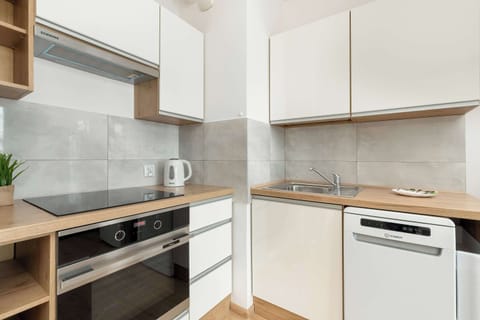 The sleek design of the kitchenette blending seamlessly with the living area.