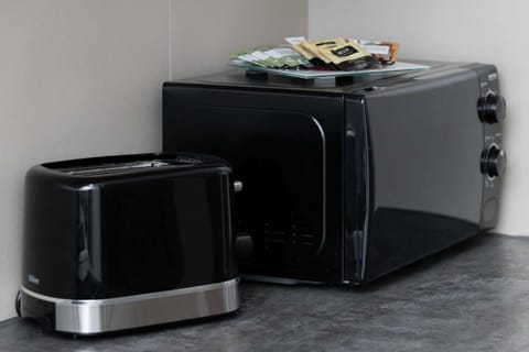 A set of small appliances, including a toaster and microwave, adds everyday convenience.

