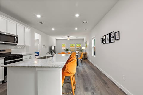 This open-concept layout connects kitchen and dining, perfect for families.