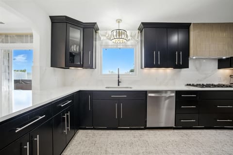 Large Kitchen has a 36" ZLINE cooktop and Quartz countertops and backsplash
