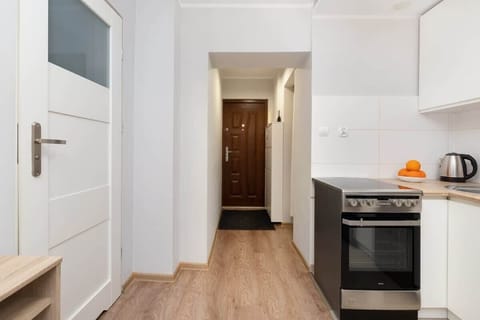 A view of the kitchen and hallway, blending simplicity and practicality with modern appliances.