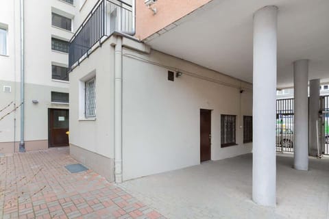 An exterior view of the building’s entrance, featuring a sheltered area and a clean, welcoming environment.