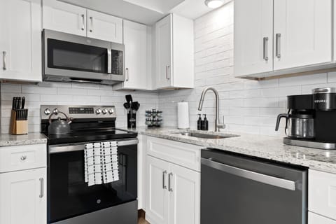 Fully equipped kitchen with stainless steel appliances and sleek finishes for easy meal prep.