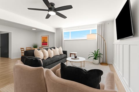 Modern layout with dual sofas and large windows—ideal for group gatherings or a quiet evening in.