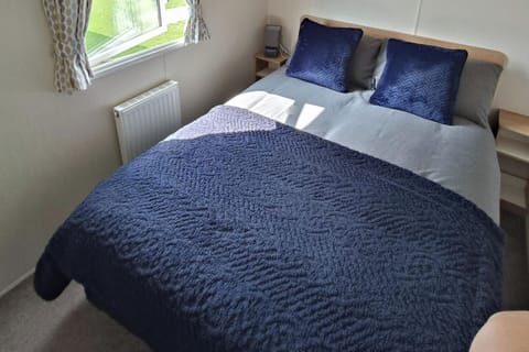 Main bedroom includes double bed, wardrobe, and vanity unit 