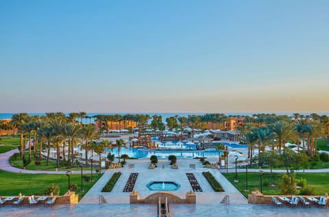 Wander through lush gardens leading to the resort’s centerpiece pool.