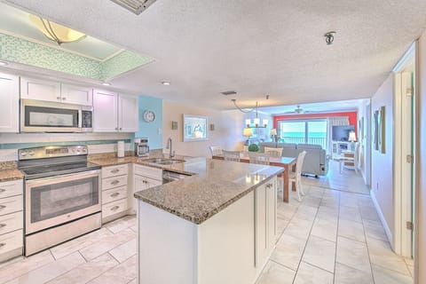 Your fully equipped kitchen features granite countertops, modern appliances, and flows seamlessly into the bright dining area with stunning ocean views.