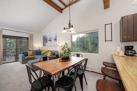 Unwind in your bright, open living space with exposed beams, mountain views, and colorful touches that make it feel like home.