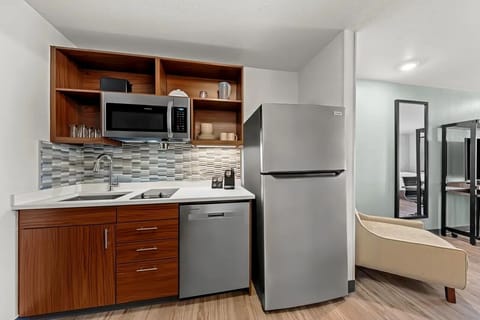 Start mornings easily with a sleek kitchenette and fridge.