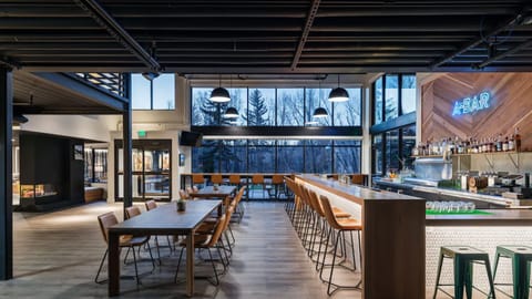 Sip craft cocktails at the lively bar with forest views.