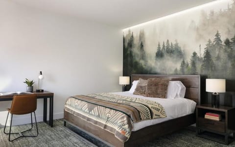 Unwind in a cozy bed framed by a dramatic mural.