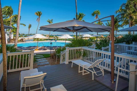 Lounge under swaying palms with serene pool views and warm breezes just steps from your door.