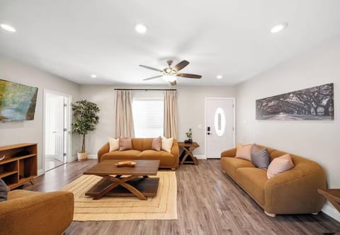 Relax in a sunlit space with chic furnishings, wood floors, and calming colors.