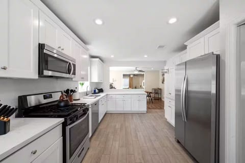 Stylish kitchen opens to dining area, perfect for cooking and gathering.