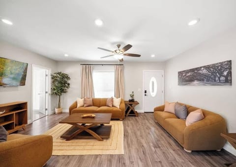 Relax in a sunlit space with chic furnishings, wood floors, and calming colors.