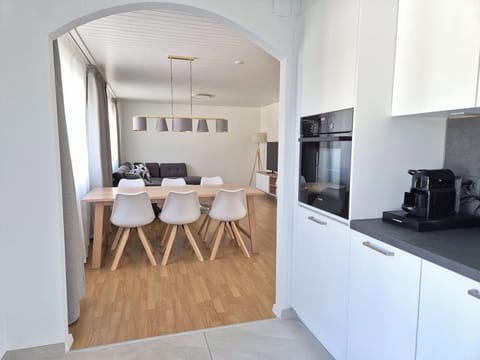View from the kitchen towards the dining table and living room