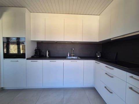 The kitchen is large and has lots of storage space.