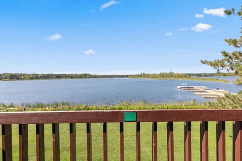 Scenic lake views from the private balcony with wooden railing.