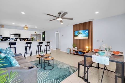 Open living and kitchen area featuring comfortable seating and a flat-screen TV.