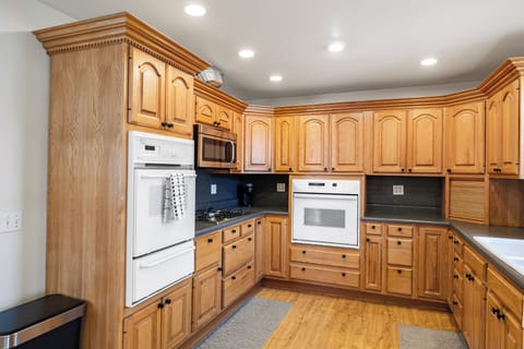 Spacious kitchen featuring natural wood cabinets, built-in oven, and ample prep space—perfect for family meals or group stays.