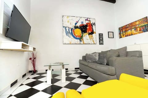 Unwind in the heart of comfort! This spacious living room, adorned with a cozy grey sofa and elegant wall art, is your personal sanctuary after a day of discovery. Perfect for quiet evenings or engaging conversations.
