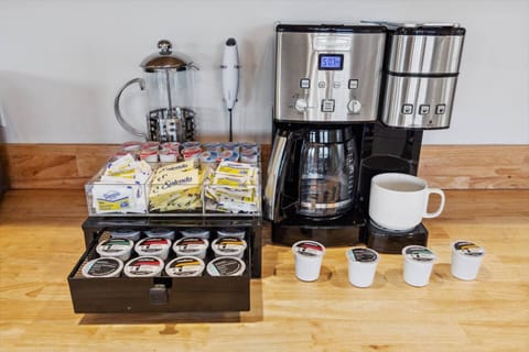 Coffee Bar with coffee maker to brew ground coffee and individual kcups. Creamers, sugar, Splenda, kcups, frother and French press.