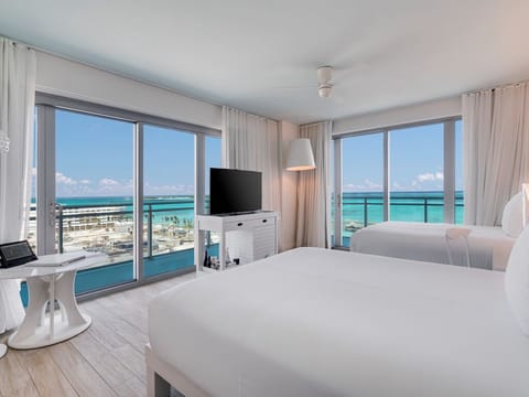Wake up to turquoise ocean views from crisp white beds.