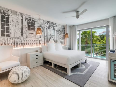 Stretch out in crisp linens beside lush tropical views.