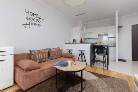 Bright living room with corner sofa, round coffee table, and open layout.