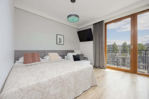 A bright and cozy area with a double bed, large windows, and access to the balcony.