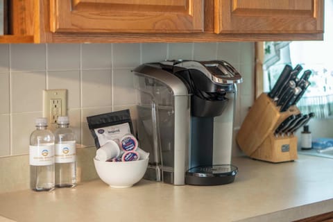 The cozy kitchen offers ample storage & every home comfort