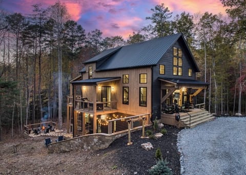 Modern luxury cabin with two decks, fire pit, and peaceful wooded surroundings