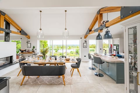 The open-plan living space boasts exposed beams