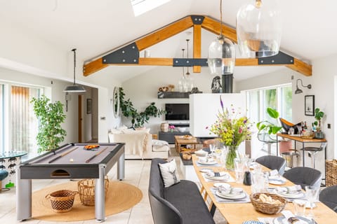 The beautiful open-plan living space boasting exposed beams