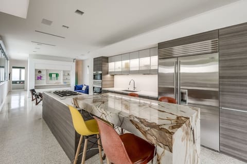The custom chef’s kitchen is the heart of the home, custom marble, Wolf gas burners, wolf steam oven, Wolf double convection oven, Subzero refrigerator, usb ports under bar. Poggenpohl cabinetry are fully stocked for all your cooking needs