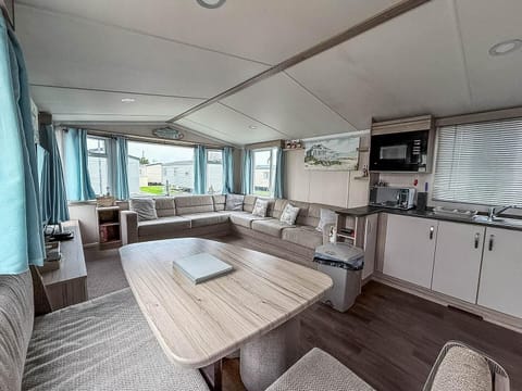 Bright and airy dining area with panoramic windows and cozy seating
