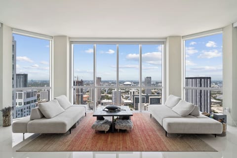 Living room with floor to ceiling windows and panoramic view of Downtown