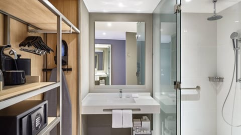 Refresh under a rainfall shower in a spotless modern bath.