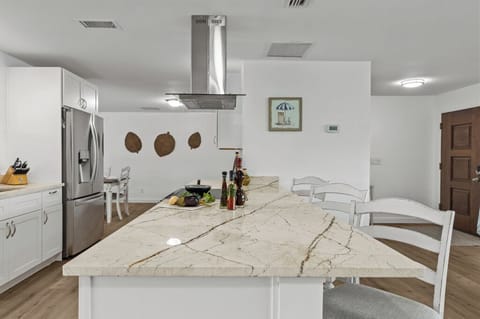 Newly renovated kitchen with granite countertops and modern appliances—designed for gathering