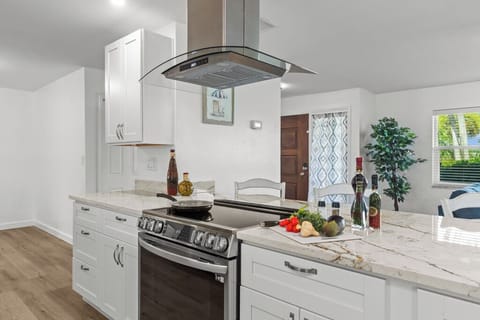 Newly renovated kitchen with granite countertops and modern appliances—designed for gathering