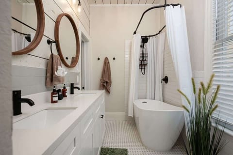 Front House Guest Bathroom with Tub/Shower Combo: Stylish retreat with dual sinks and a relaxing tub perfect for unwinding!