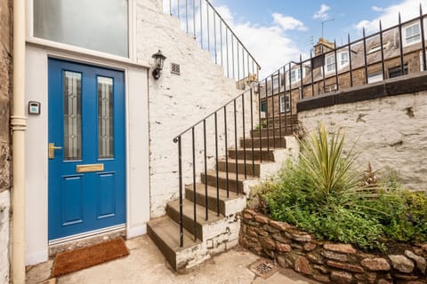 Front door with stairs and small courtyard garden