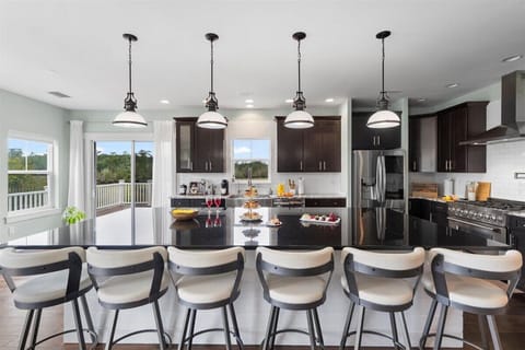 Cook, connect, and entertain in this sleek modern kitchen featuring a sprawling island with seating for 6 stainless steel appliances, a gas range, and fully stocked prep space. Whether you’re whipping up family meals or enjoying charcuterie and wine with